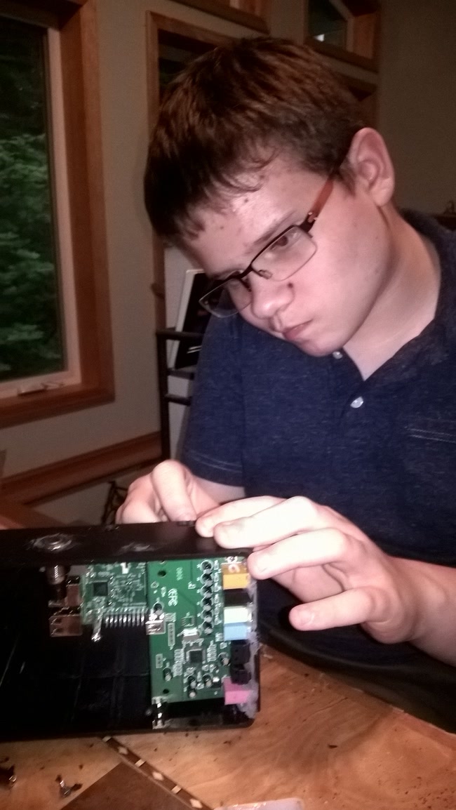 Screwing the Raspberry Pi into the enclosure.